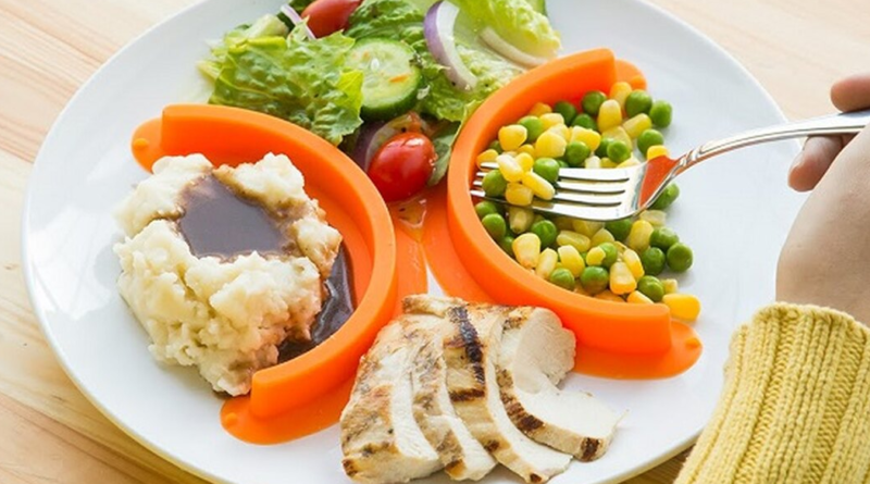 Image of a plate divided for portion control: half with vegetables, a quarter with lean protein, and a quarter with whole grains